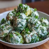 Tender-crisp Brussels Sprouts in Cream Cheese-Mustard Sauce coated in a rich, golden Dijon cream sauce, ready to serve.