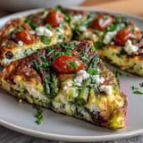 Healthy Easy Spring Veggie Frittata with fresh asparagus, spinach, and cherry tomatoes baked to golden perfection in a skillet.