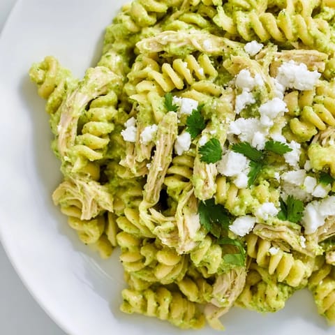 Hearty Cilantro Lime Chicken Pasta with rotini noodles, shredded chicken, and vibrant herbs, ready to serve for a weeknight dinner.  