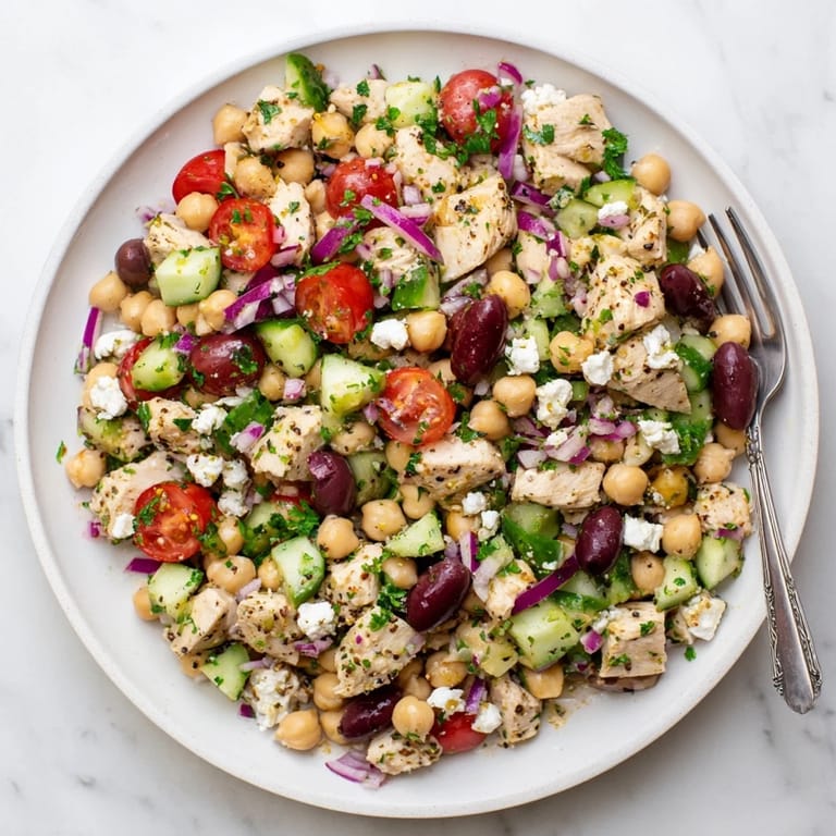 Easy Mediterranean Chickpea Chicken Salad served over mixed greens, perfect for a refreshing high-protein lunch or light dinner.