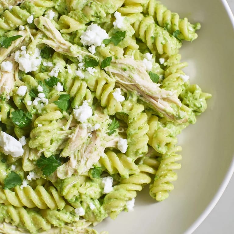 Close-up of Cilantro Lime Chicken Pasta showing juicy chicken, bright cilantro garnish, and a tangy yogurt sauce coating every spiral.