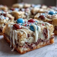 Colorful graduation cookie bars with chocolate chips and white chocolate drizzle, perfect for celebrating success and easy to customize with school colors.